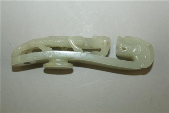 A Chinese pale celadon jade dragon belt hook, 18th / 19th century, 10cm,